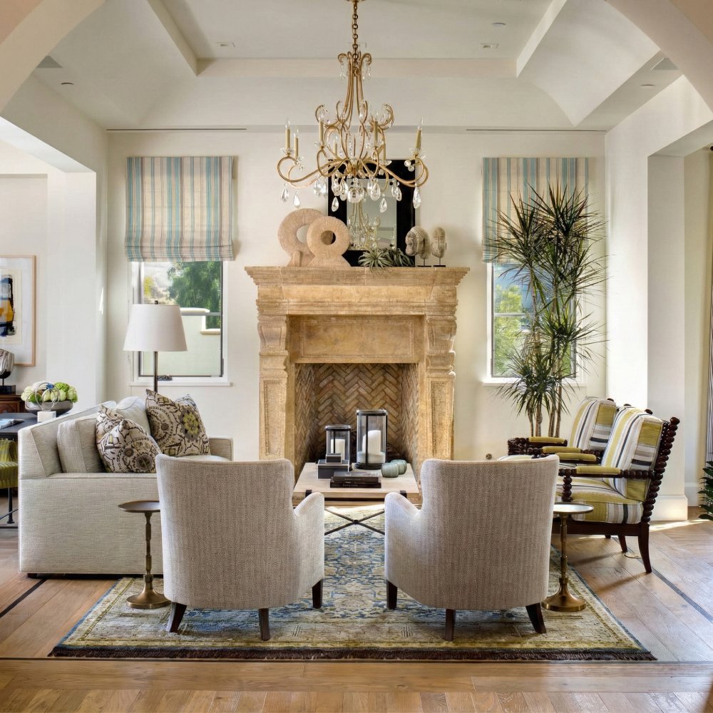 Symmetrical window treatment featuring two custom striped roman shades flanking a large stone fireplace.