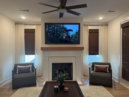Custom pinch pleat curtains hanging on a decorative rod with rings showing 2x fullness in a modern living room.