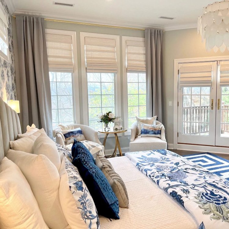 Natural bamboo roman shades in a breezy coastal style bedroom.