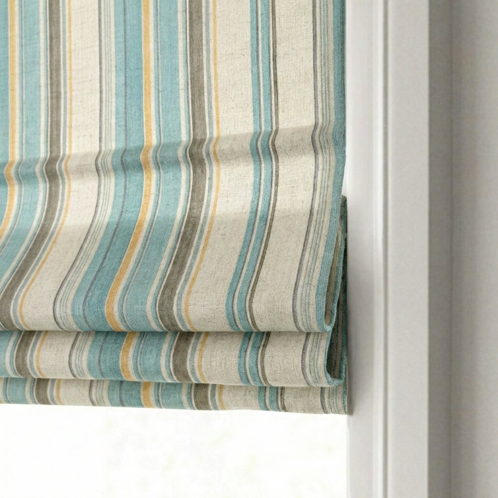 Side profile of the classic flat fold stacking mechanism on a striped linen-blend roman shade.