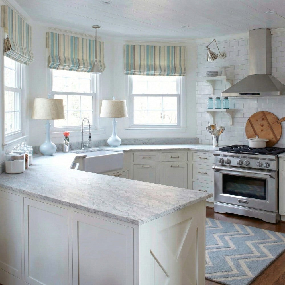 Three custom-made striped roman shades perfectly fitted for a bright kitchen bay window.