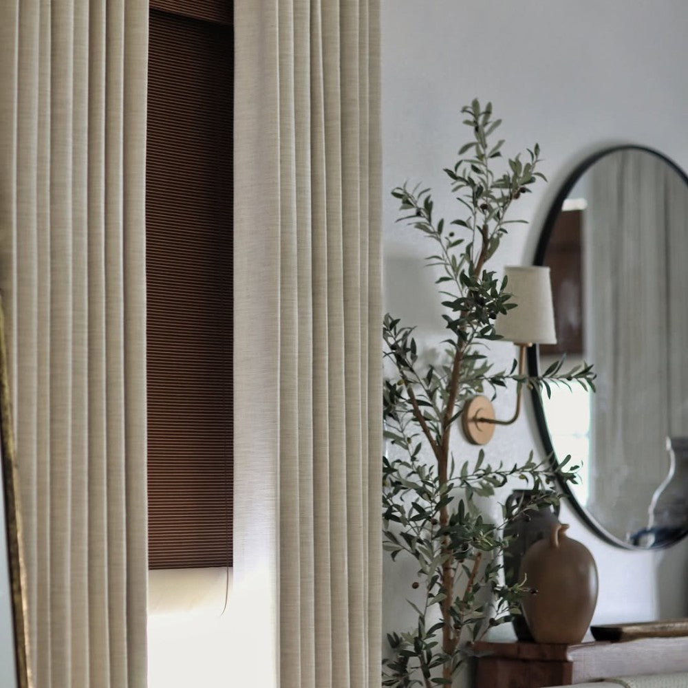 Detailed view of pinch pleat linen curtains featuring memory shaping for perfect hanging folds