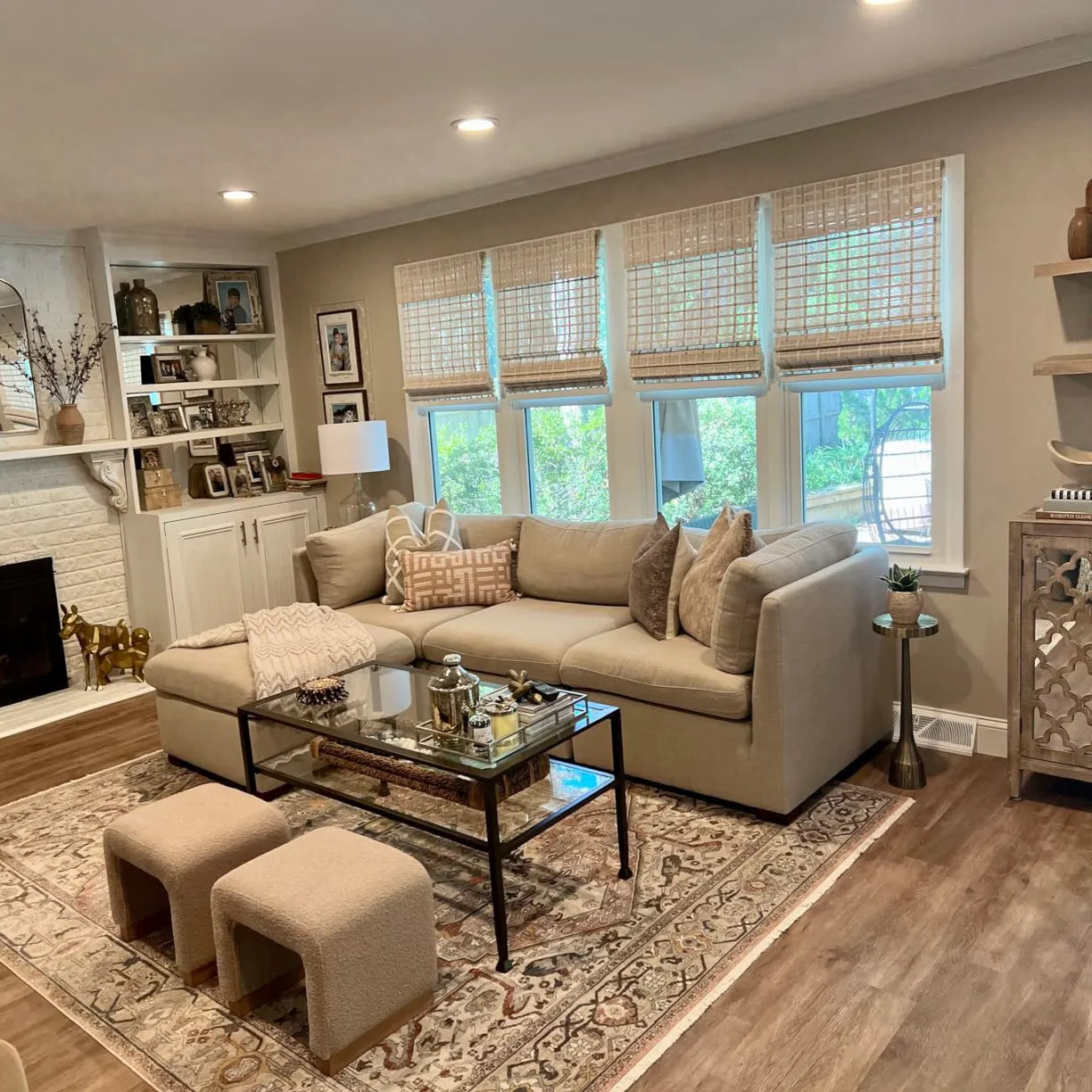 Bright living room decorated with white bamboo shades for windows.
