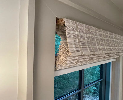 White bamboo shades in fully raised position for clean look.