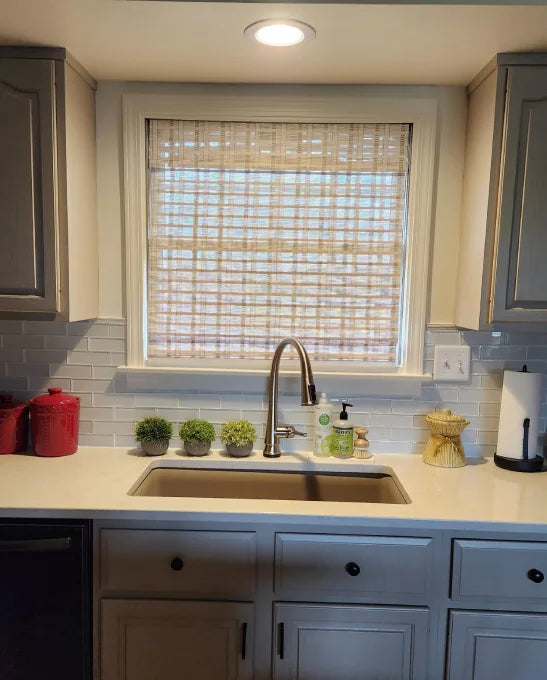 White bamboo window shades installed in a sunlit kitchen.