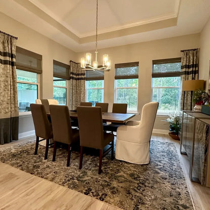 No-Drill Cordless Brown Bamboo Roman Shades in dining room, creating a warm and inviting atmosphere