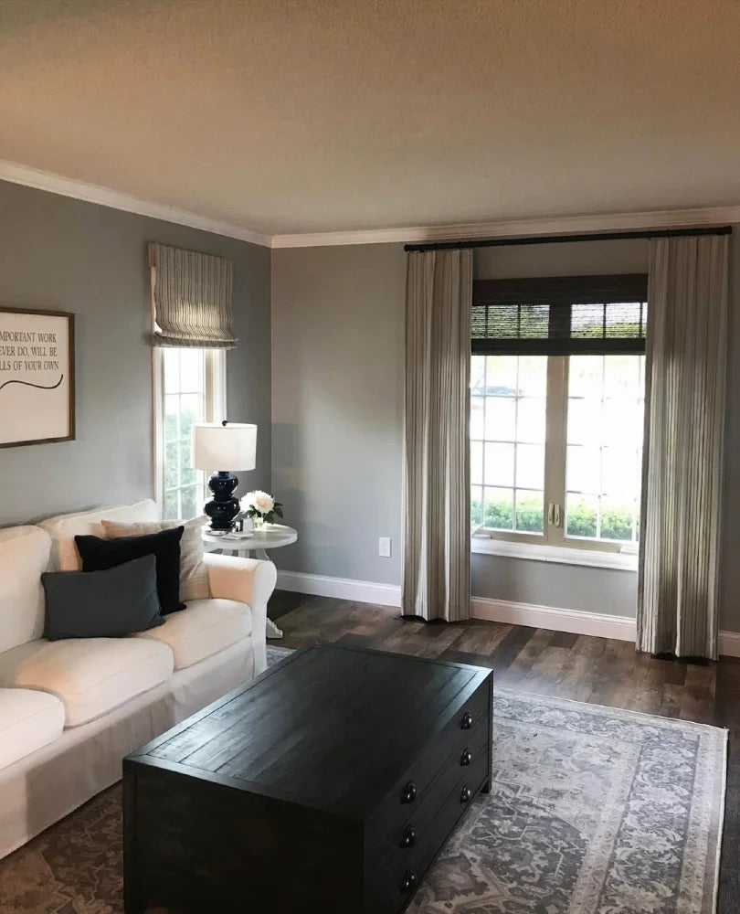 No-Drill Cordless Brown Bamboo Roman Shades hanging in the living room, providing soft light diffusion and privacy