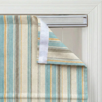 Close-up of custom striped linen roman shade in sage green and light blue, showing the vertical stripe pattern.