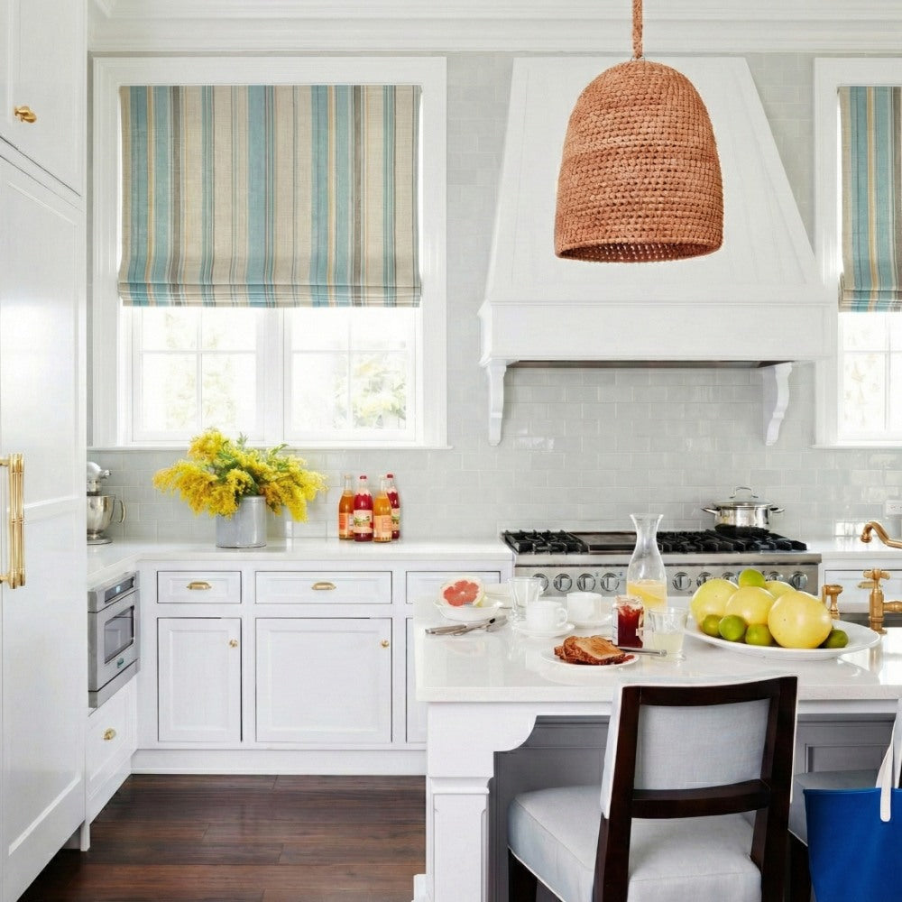 Coastal style kitchen interior with custom striped roman shades providing light filtering and privacy.