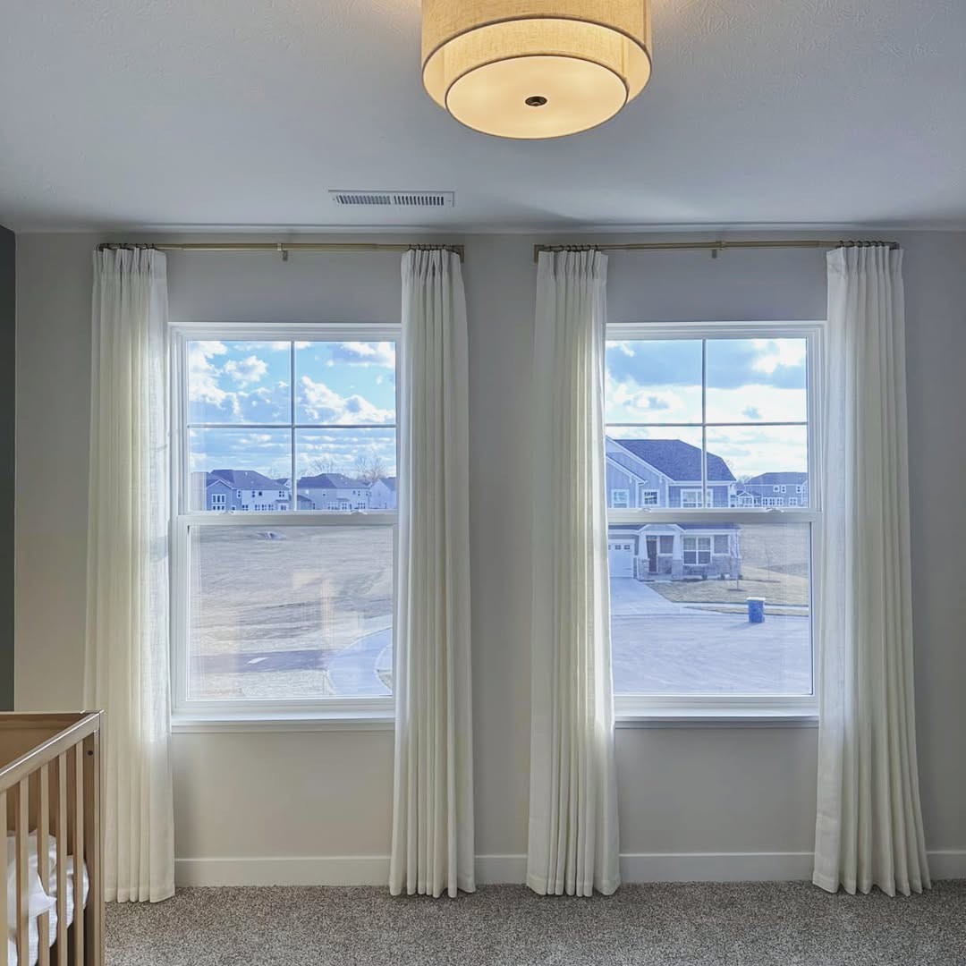 Custom white pinch pleat linen curtains perfectly fitted for a large bedroom window hanging view